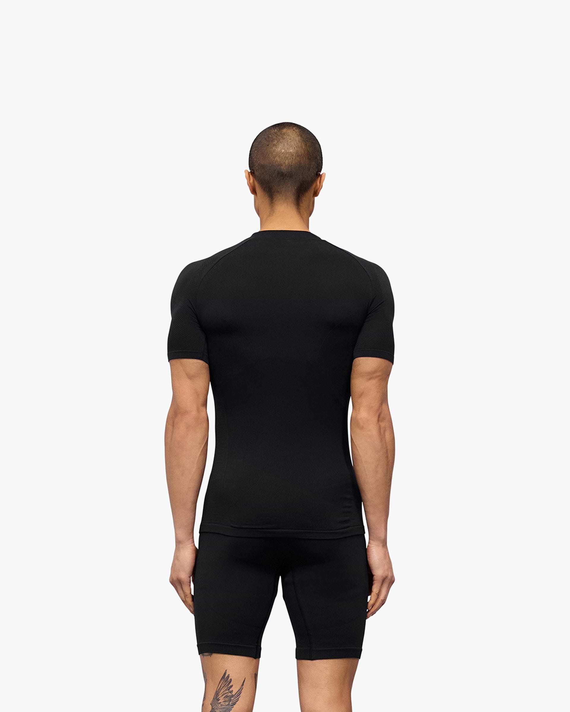 Man wearing a black seamless t-shirt on a plain white background | 247 DNA Seamless T-Shirt in Black | Seamless slim fit t-shirt for performance | 247 T-Shirts | Represent Clo