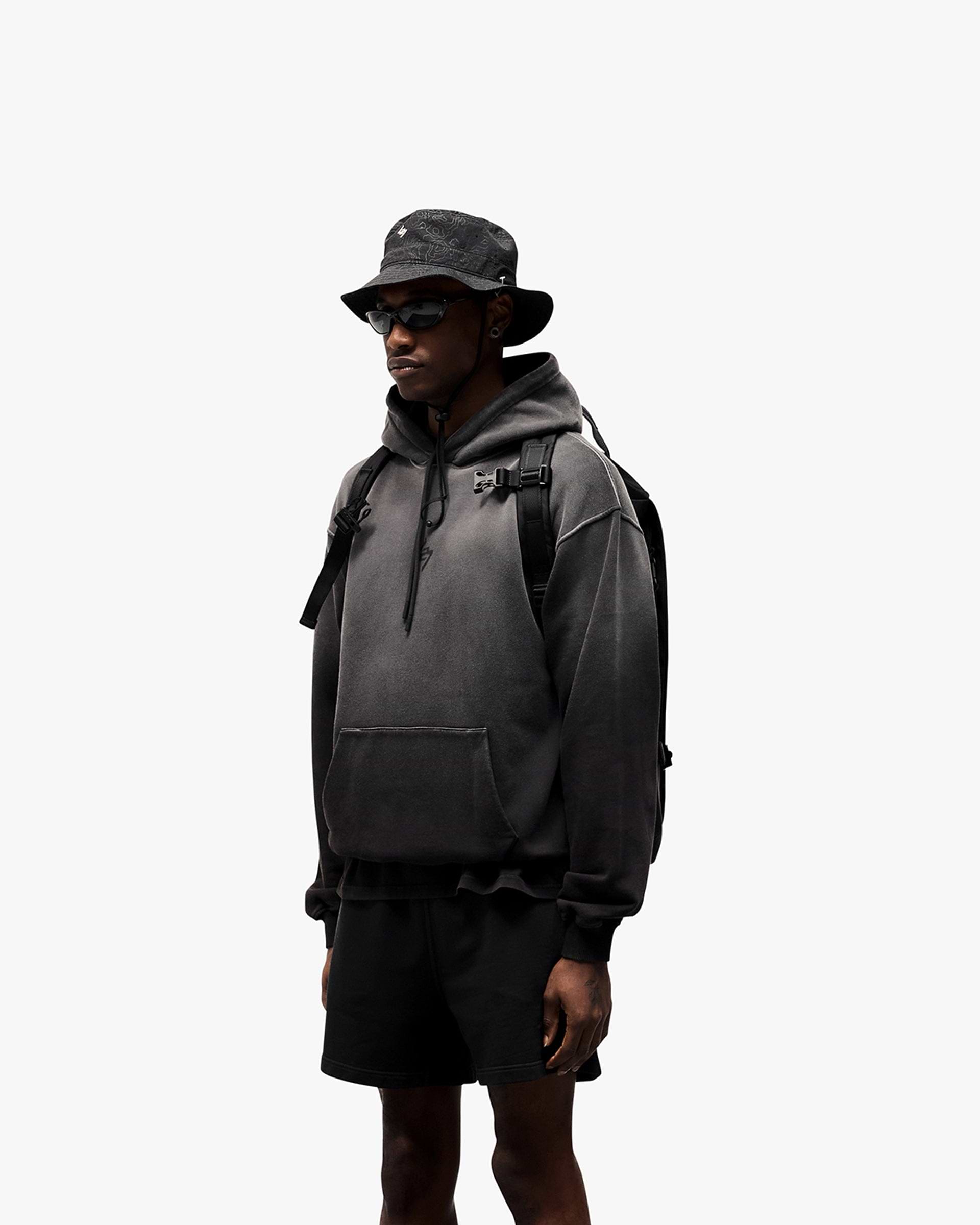 Man wearing a black oversized hoodie on a plain white background | 247 Motion Oversized Hoodie in Black | Oversized hoodie with ribbed hem and cuffs | 247 Hoodies | Represent Clo