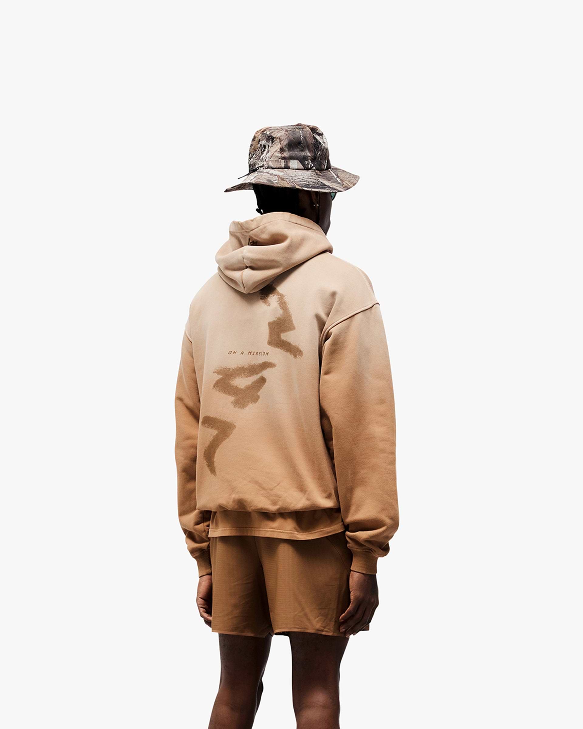 Man wearing an oversized rust hoodie on a plain white background | 247 Motion Oversized Hoodie in Rust | Hoodie with ribbed hem and cuffs | 247 Hoodies | Represent Clo