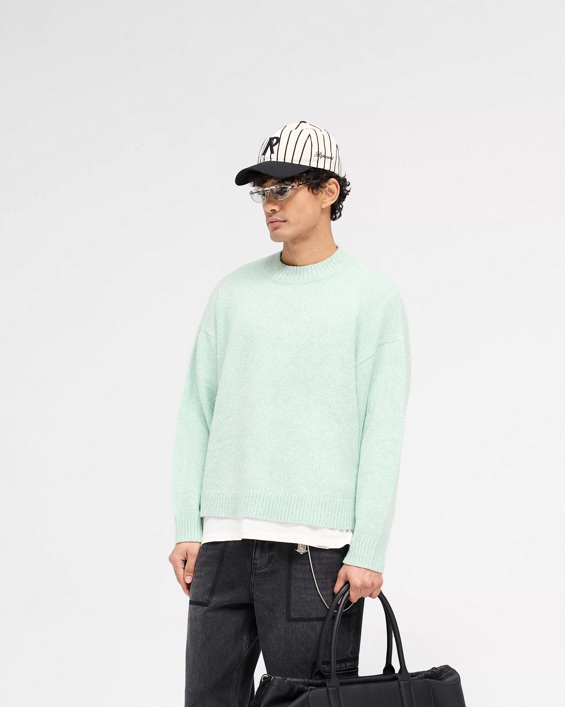 Back product image of a mens green knit jumper on a plain white background | Marled Knit Jumper in Matcha | Knitwear with ribbed collar, cuffs, and hem | SS25 Knitwear | Represent Clo