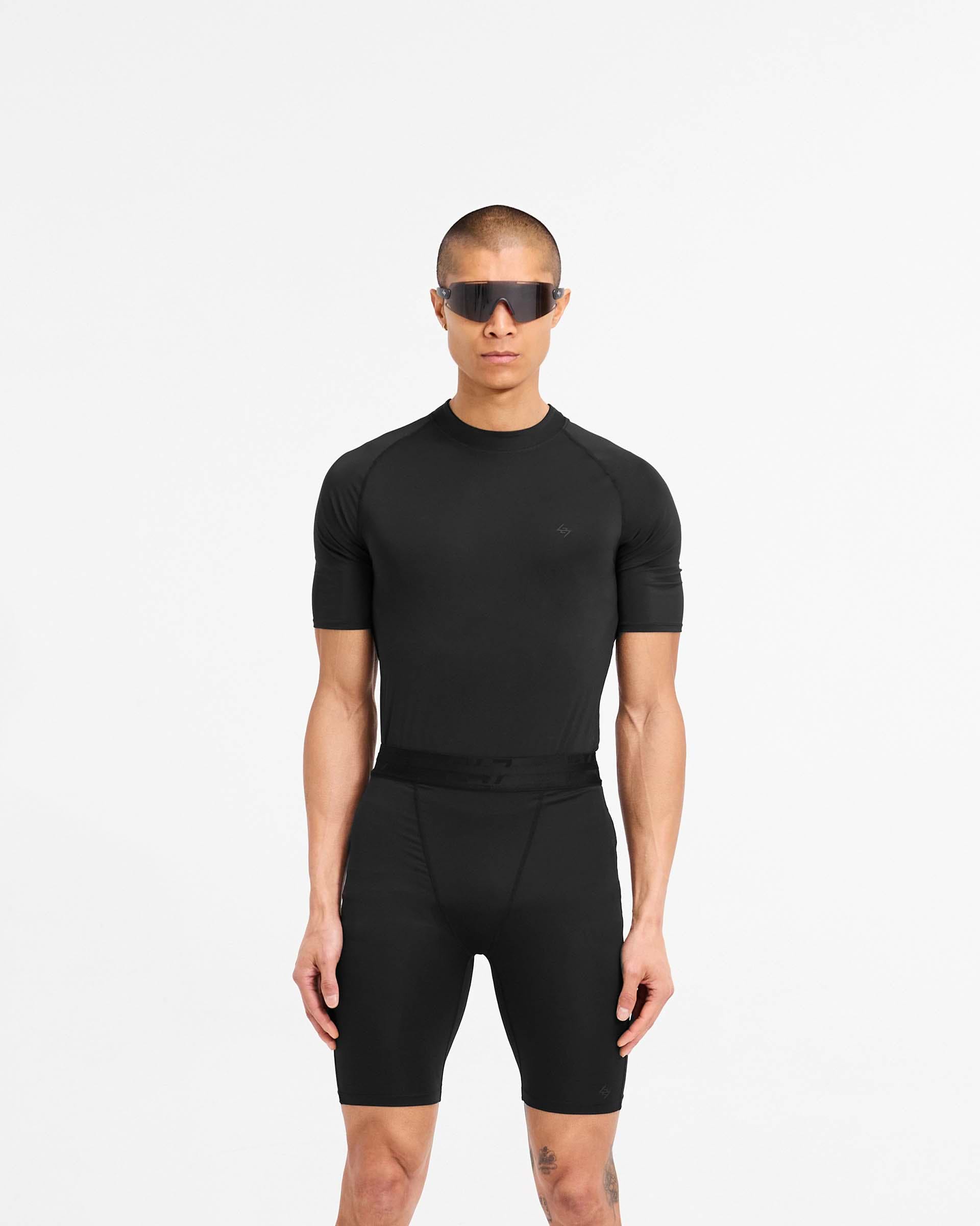 Man wearing a black t-shirt on a plain white background | 247 Compound T-Shirt in Black | T-shirt with raglan sleeves and sweat wicking technology | 247 T-Shirts | Represent Clo