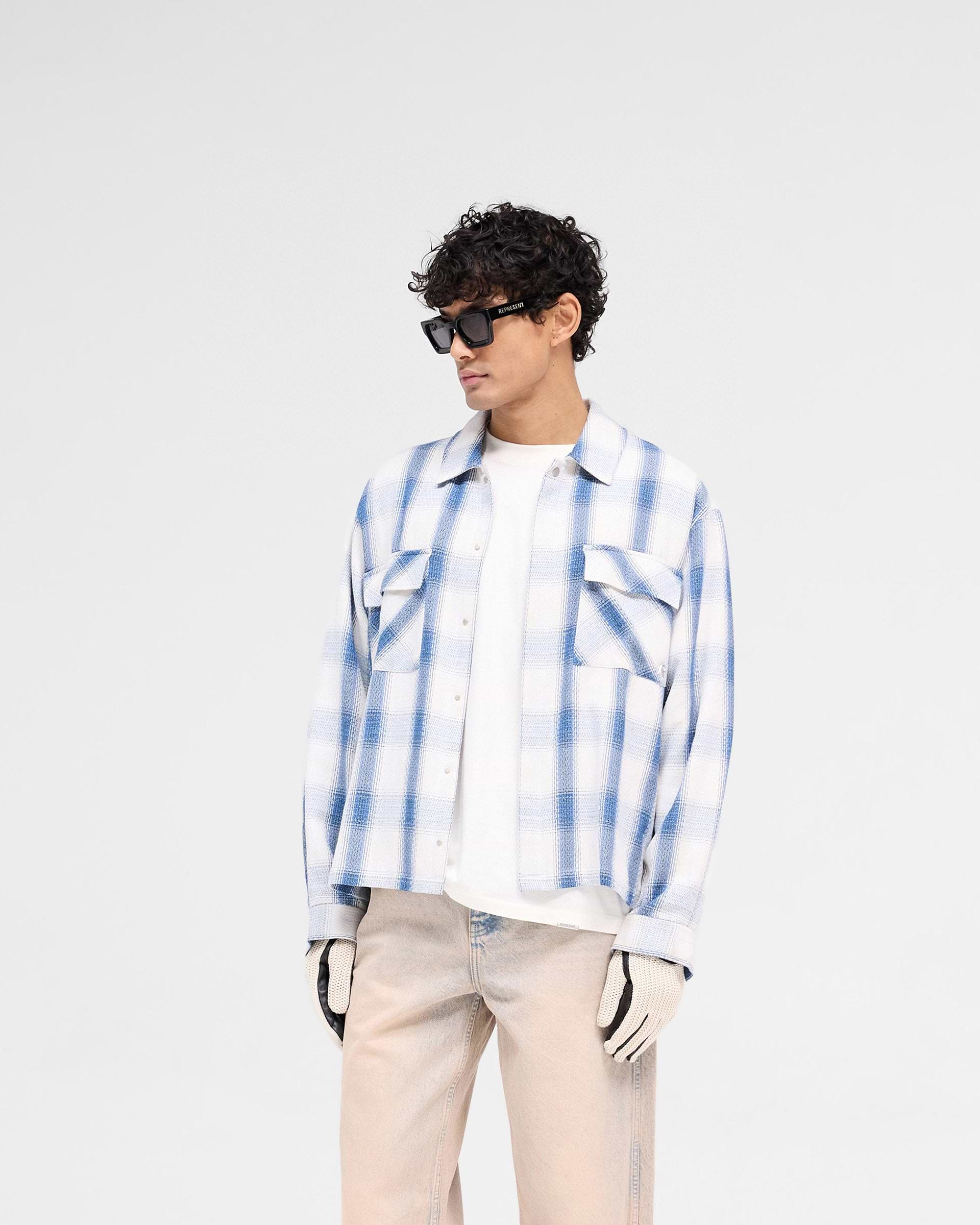 Back product image of a mens blue flannel shirt on a plain white background | Season Flannel Shirt in Mid Blue | Textured flannel shirt with embroidered back logo | SS25 Shirts | Represent Clo