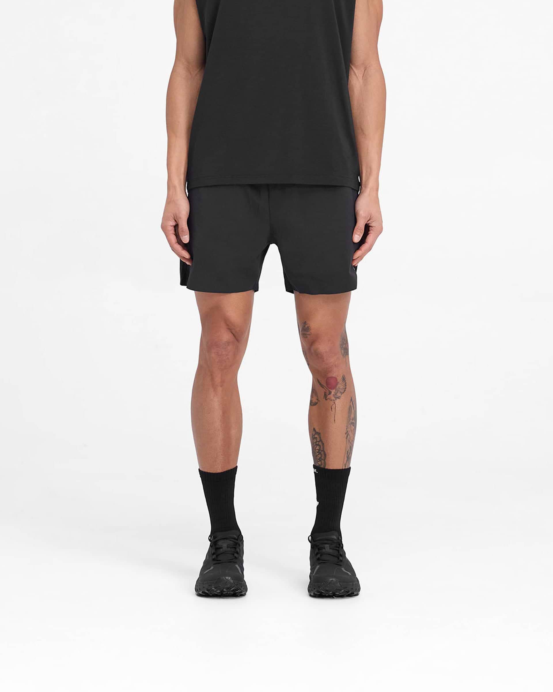 Man wearing black training shorts on a plain white background | Team 247 Fused Shorts in Black | Shorts with branded waistband and 4-way stretch | 247 Shorts | Represent Clo