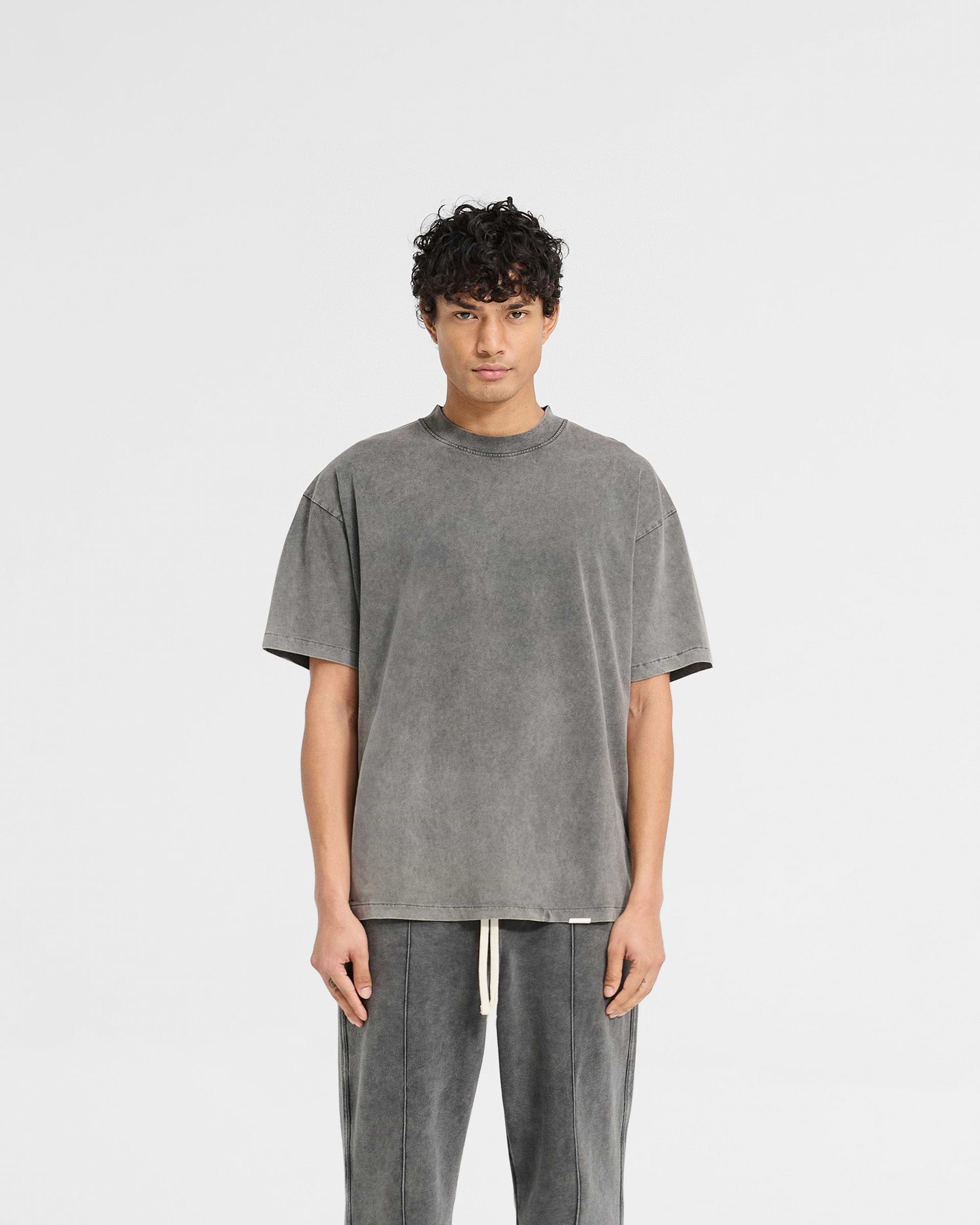 Man wearing a grey oversized t-shirt on a plain white background | Initial Oversized T-Shirt in Vintage Grey | T-shirt with embroidered back neck | Initial T-Shirts | Represent Clo