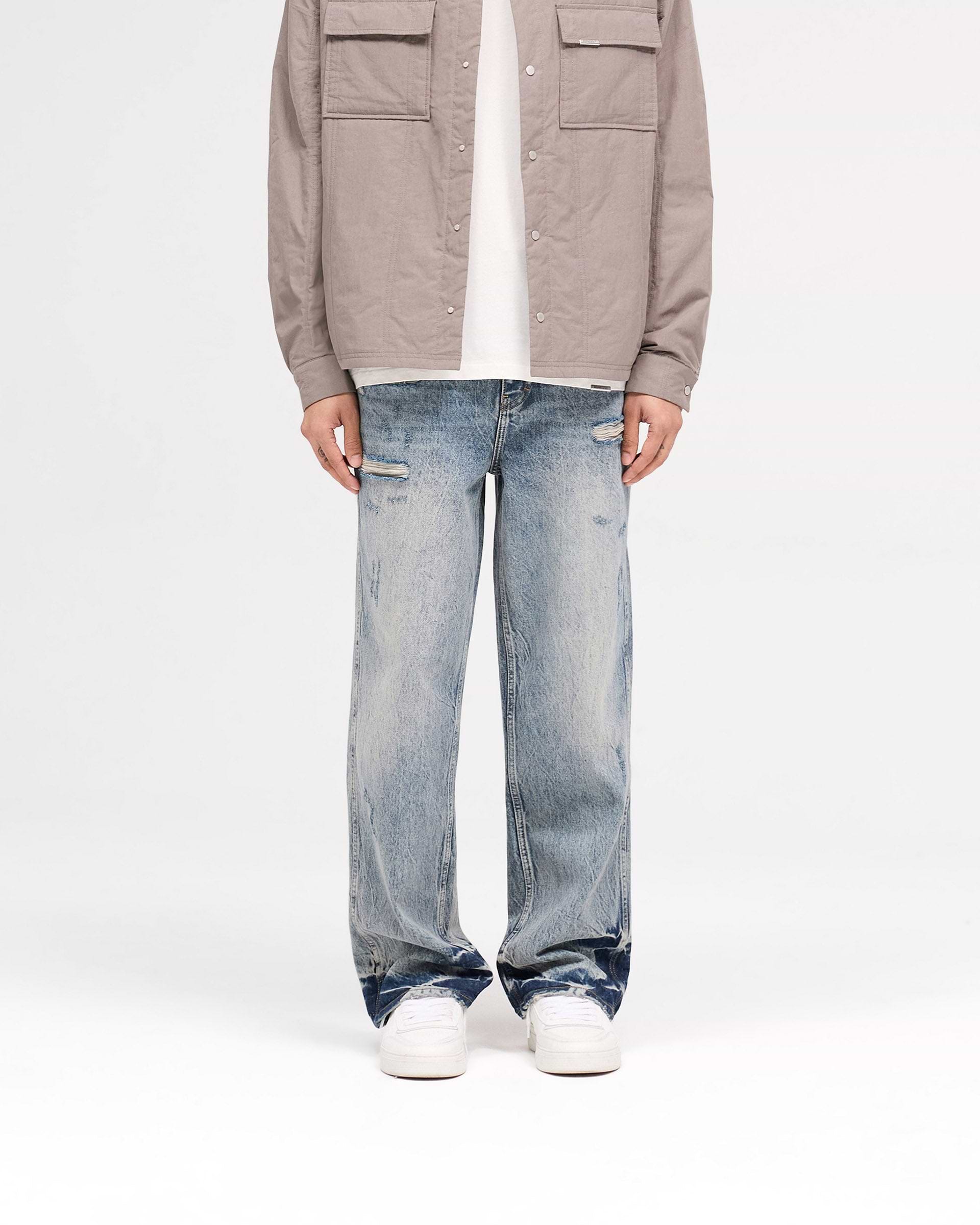 Back product image of mens blue denim on a plain white background | R3 Distressed Baggy Denim in Blue Cream | Baggy fit denim with ripped details and Initial embroidery | SS25 Denim | Represent Clo
