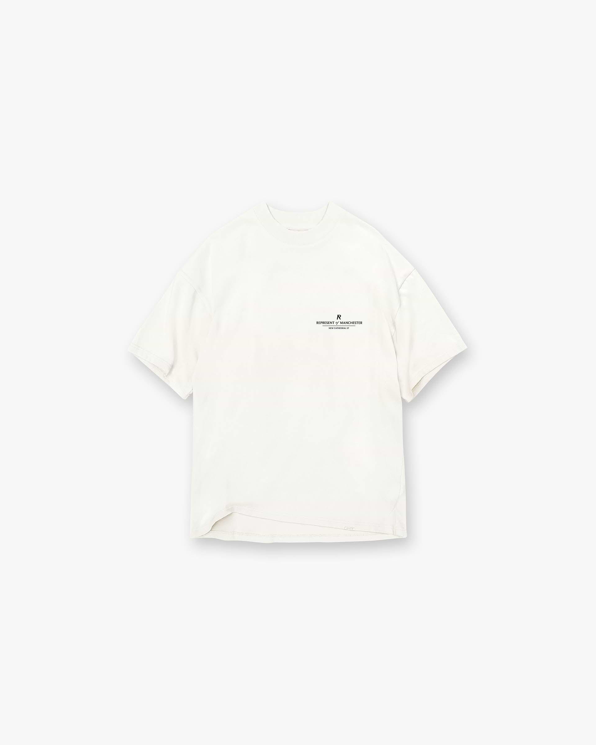 Front product image of a mens white t-shirt on a plain white background | Manchester Store T-Shirt in Flat White | Premium cotton t-shirt with exclusive branding | Exclusives T-Shirts | Represent Clo