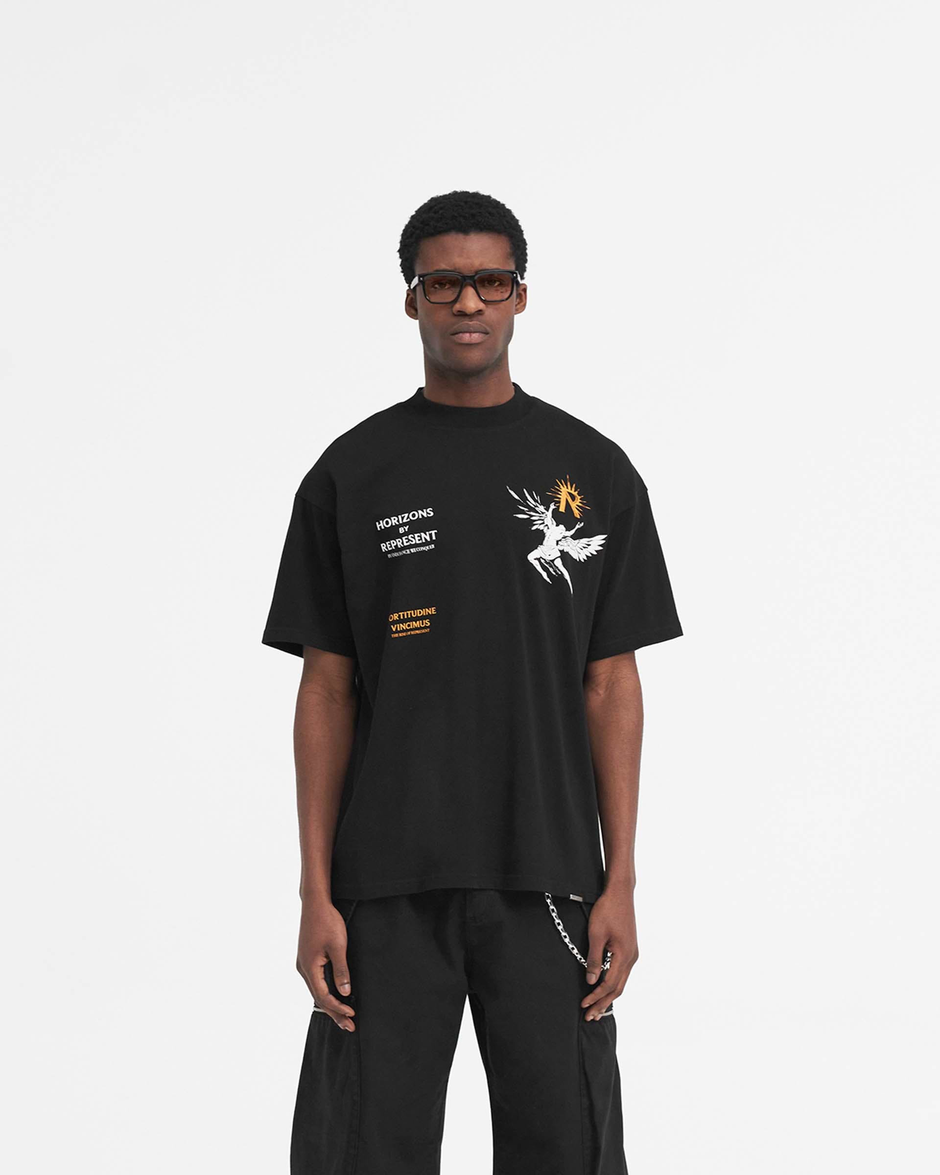 Man wearing a black t-shirt with graphic on a plain white background | Icarus T-Shirt in Jet Black | Oversized fit t-shirt with Icarus graphic | SS24 T-Shirts | Represent Clo