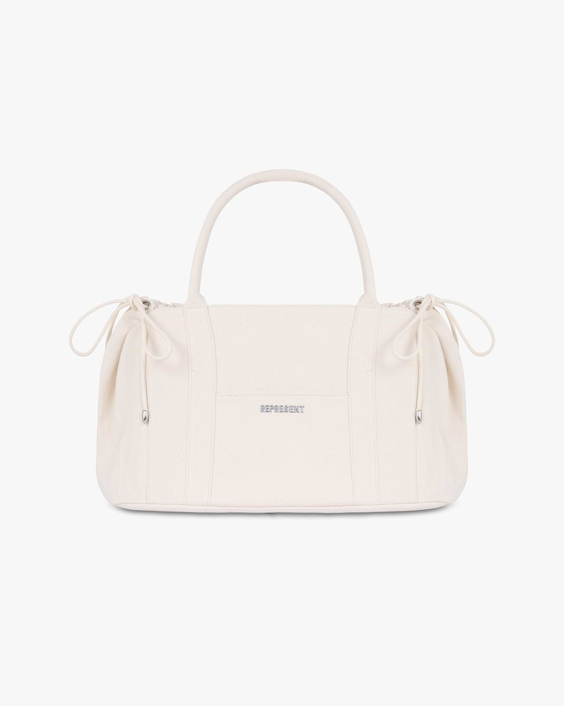 Front product image of a mens white canvas bag on a plain white background | Canvas Holdall in Antique White | Durable canvas bag with spacious interior | SS25 Accessories | Represent Clo