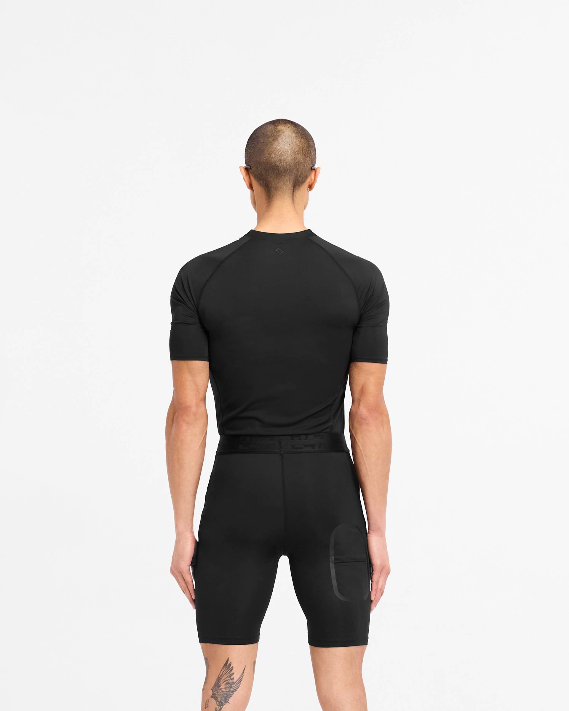 Man wearing a black t-shirt on a plain white background | 247 Compound T-Shirt in Black | T-Shirt with raglan sleeves and flatlock stitching | 247 T-Shirts | Represent Clo