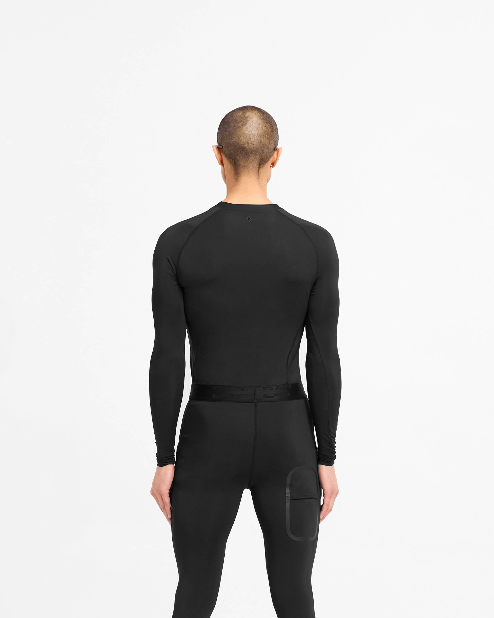 Man wearing a black long sleeve t-shirt on a plain white background | 247 Compound Long Sleeve T-Shirt in Black | Antibacterial quick drying t-shirt with raglan sleeves | 247 T-Shirts | Represent Clo