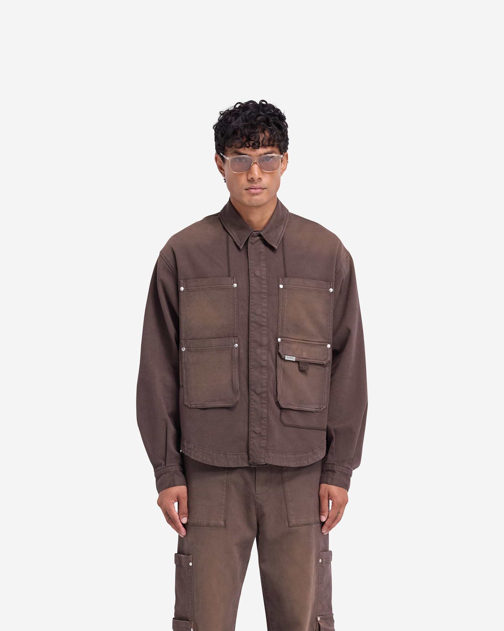 Man wearing a cedar overshirt on a plain white background | Workshop Shirt in Cedar | Everyday overshirt with concealed popper closures | FW24 Shirts | Represent Clo