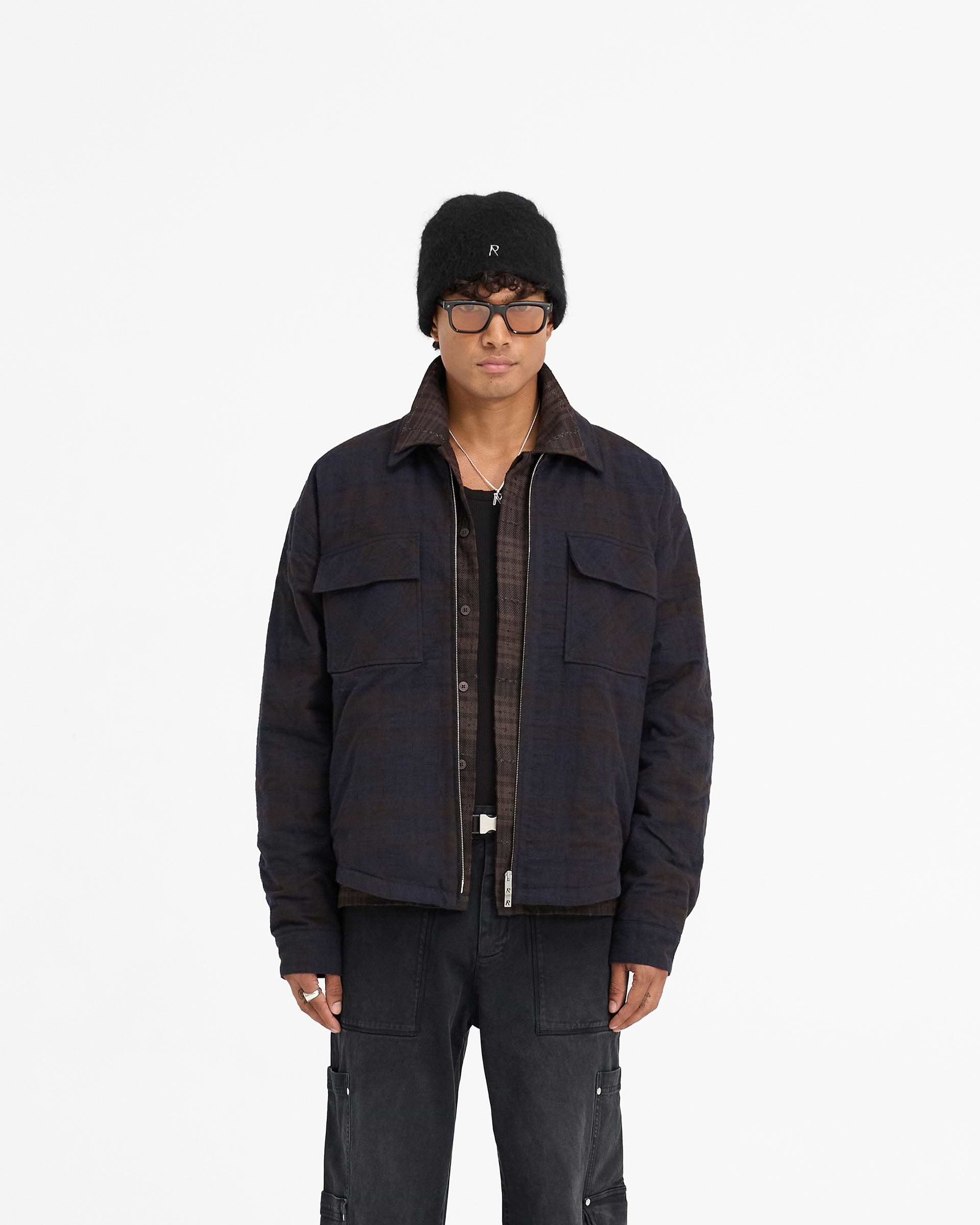 Man wearing a navy overshirt on a plain white background | Wadded Zip Overshirt in Midnight Navy | Luxury wadded overshirt with zip closure and pockets | FW24 Shirts | Represent Clo