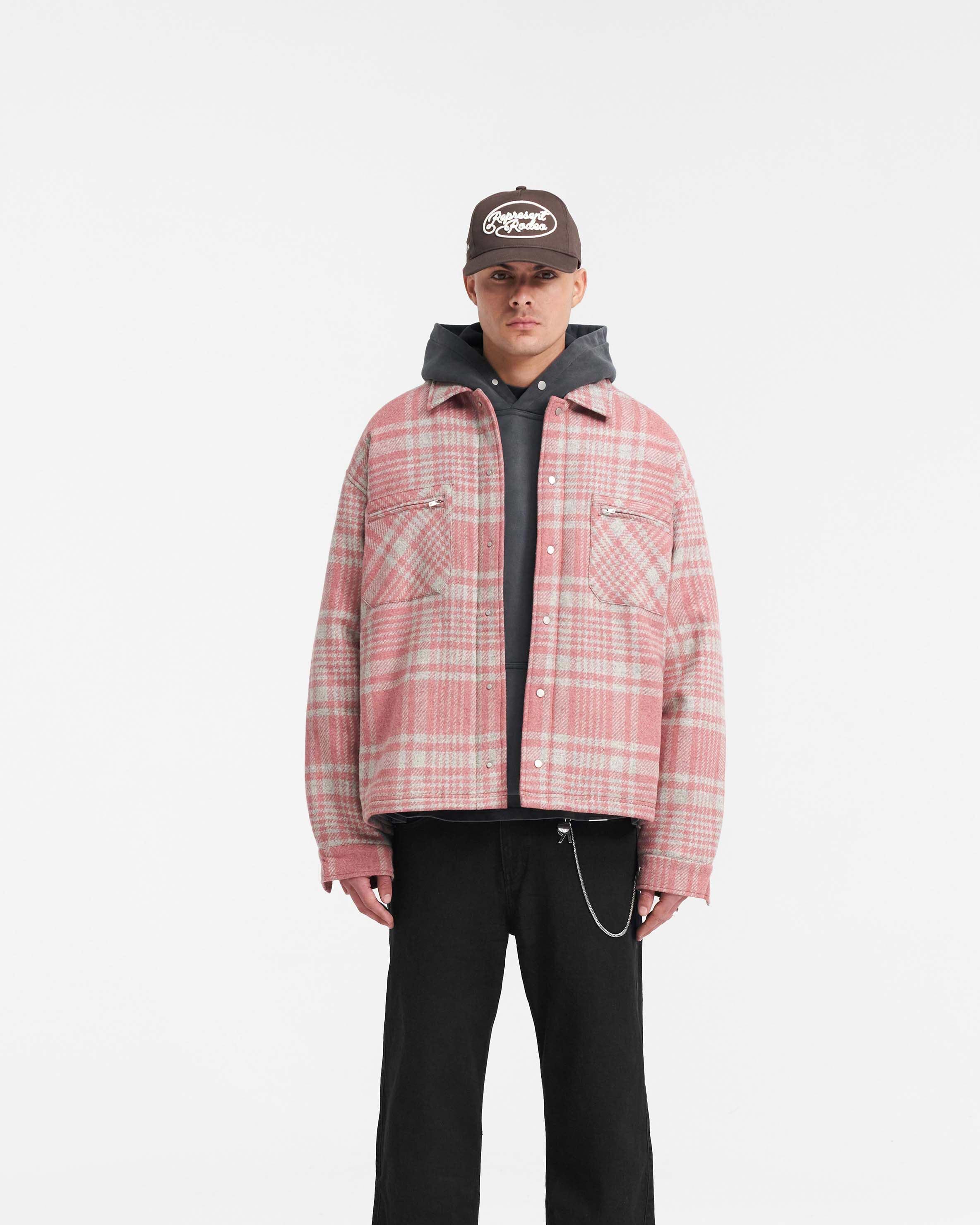 Man wearing a pink and grey check flannel shirt on a plain white background | Quilted Flannel Shirt in Pink Grey Check | Quilted shirt with patch zip pockets and split hem | PRE SS24 Shirts | Represent Clo