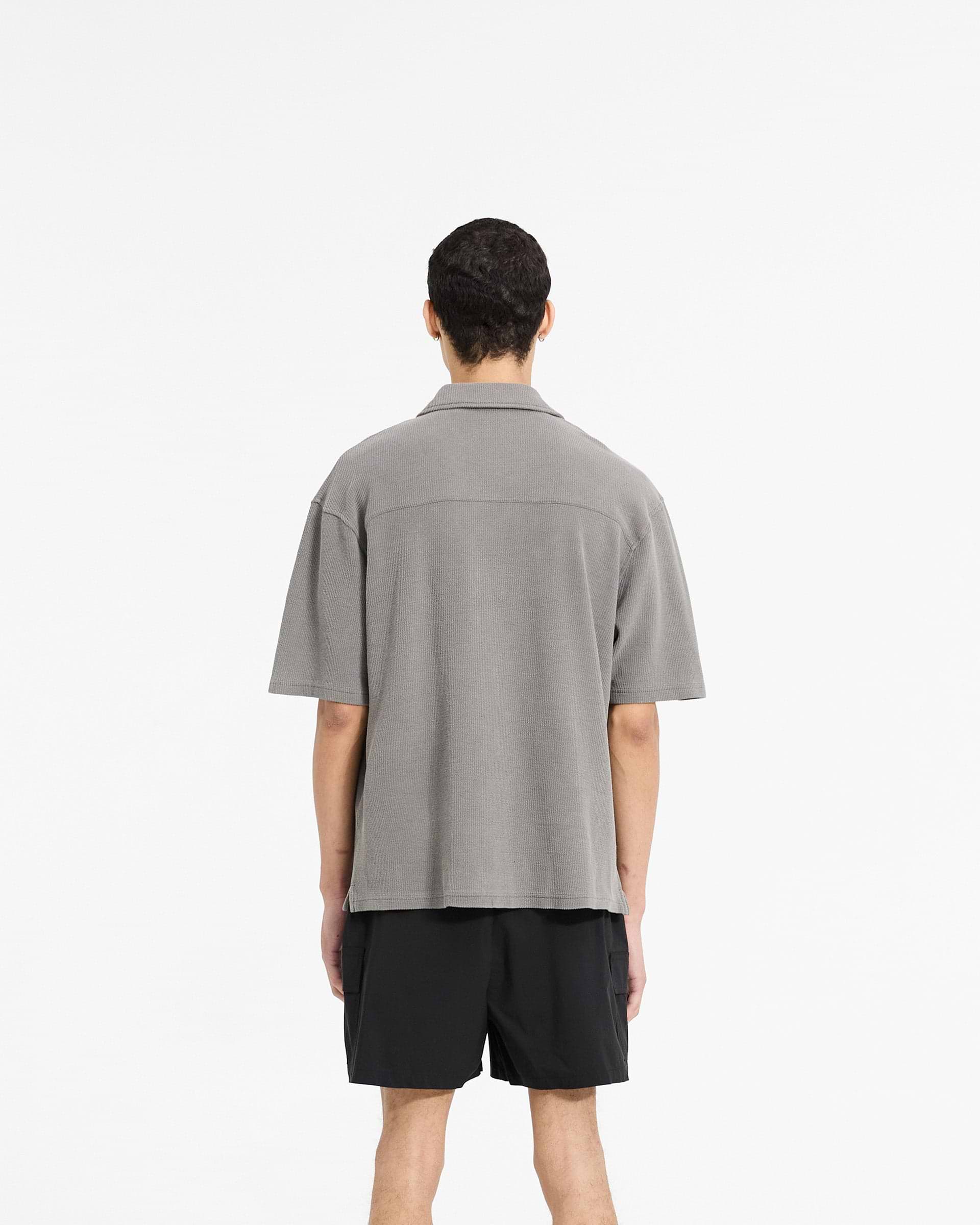 Man wearing a grey drapey shirt on a plain white background | Waffle Shirt in Ultimate Grey | Drapey fit shirt with revere collar | SC24 Shirts | Represent Clo