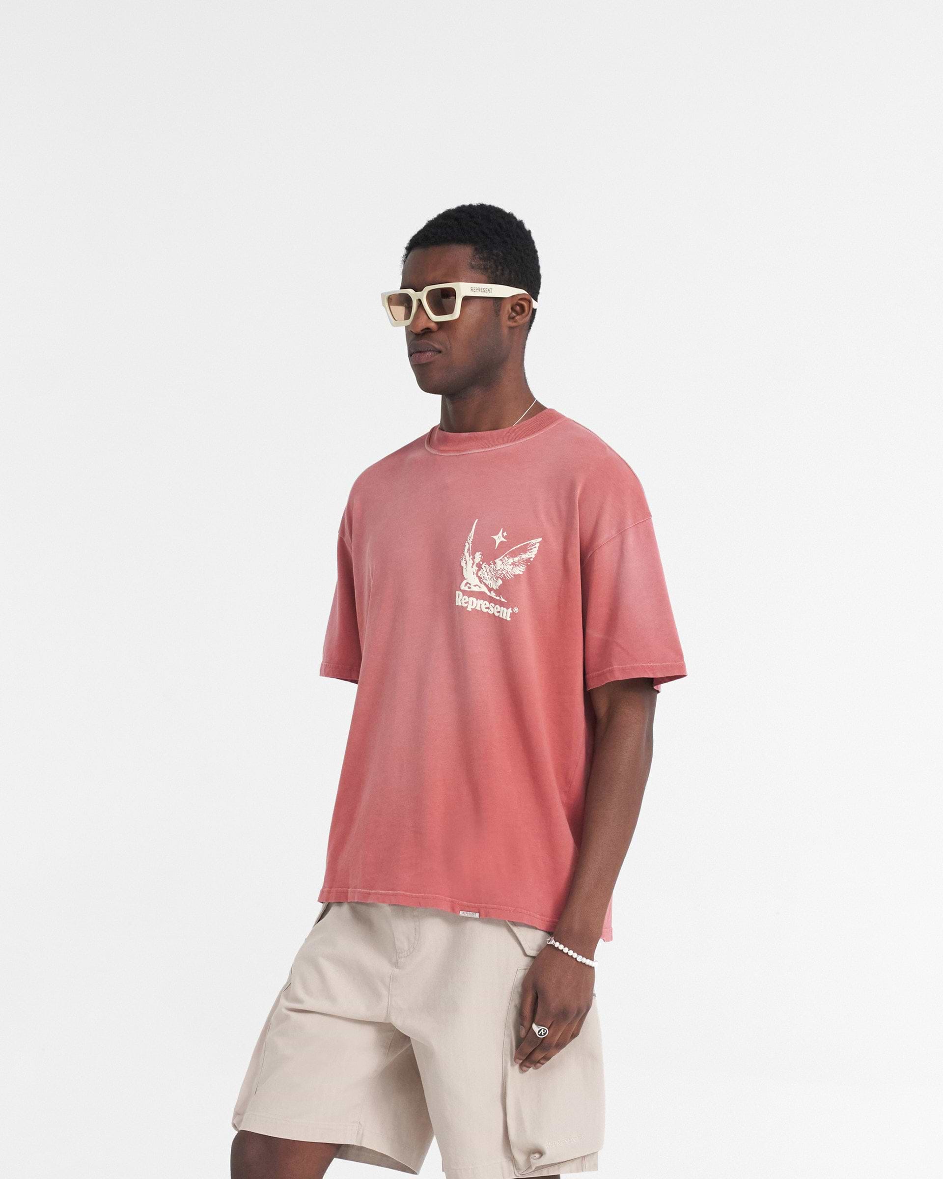 Man wearing a sunrise gradient t-shirt on a plain white background | Spirits Of Summer T-Shirt in Sunrise | Oversized t-shirt with puff print graphics front and back | SS24 T-Shirts | Represent Clo