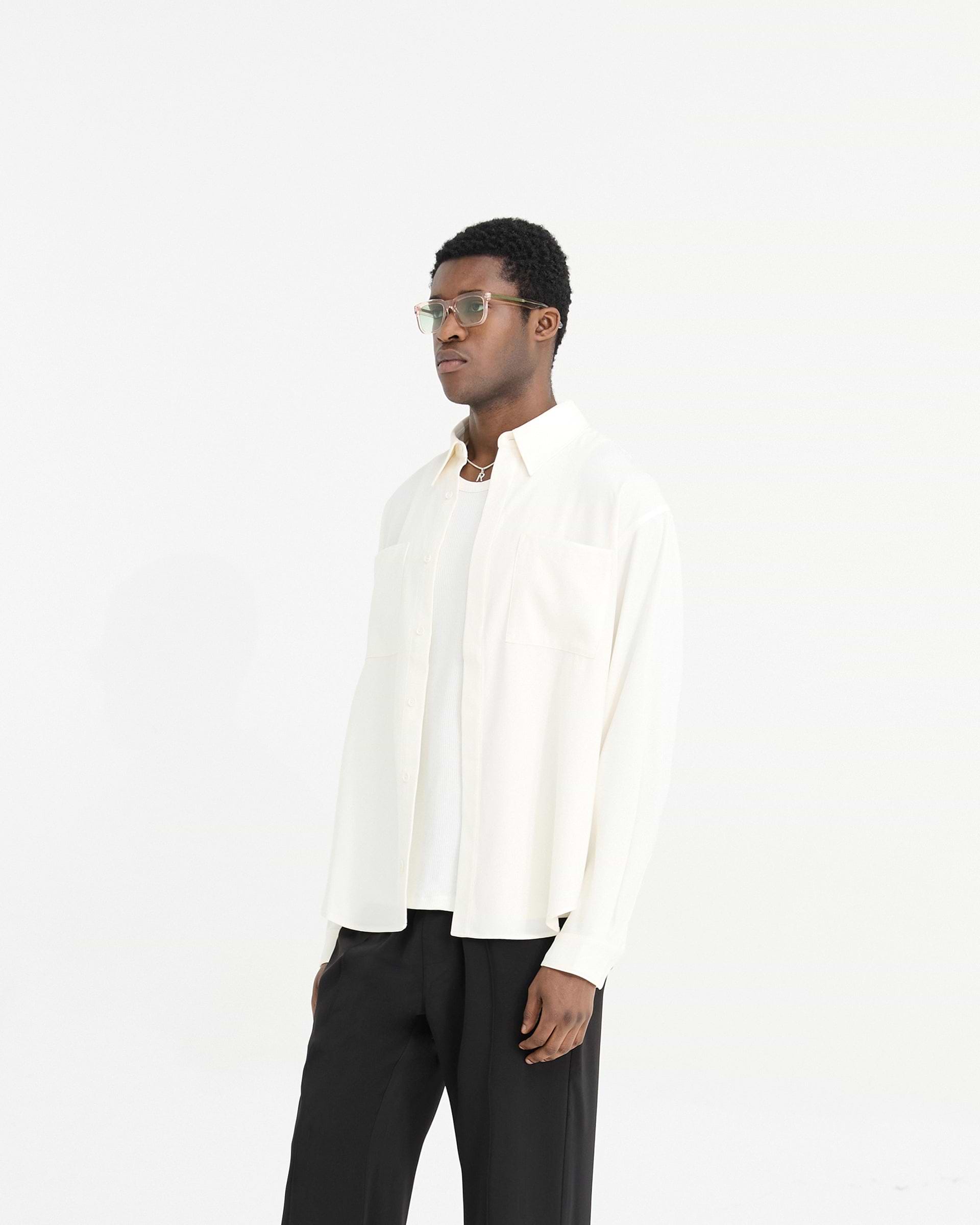 Man wearing a white shirt on a plain white background | Initial Shirt in Flat White | Shirt with chest pockets and concealed placket | Initial Shirts | Represent Clo