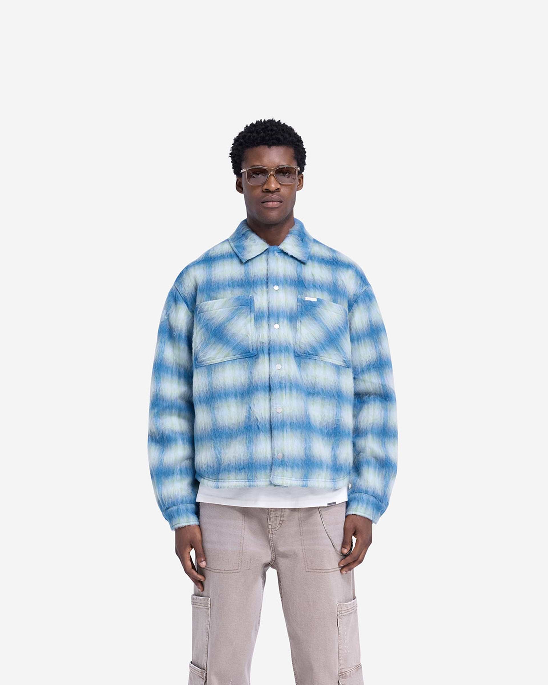 Man wearing an electric blue overshirt on a plain white background | Textured Overshirt in Electric Blue | Slightly oversized shirt with popper closures | FW24 Shirts | Represent Clo