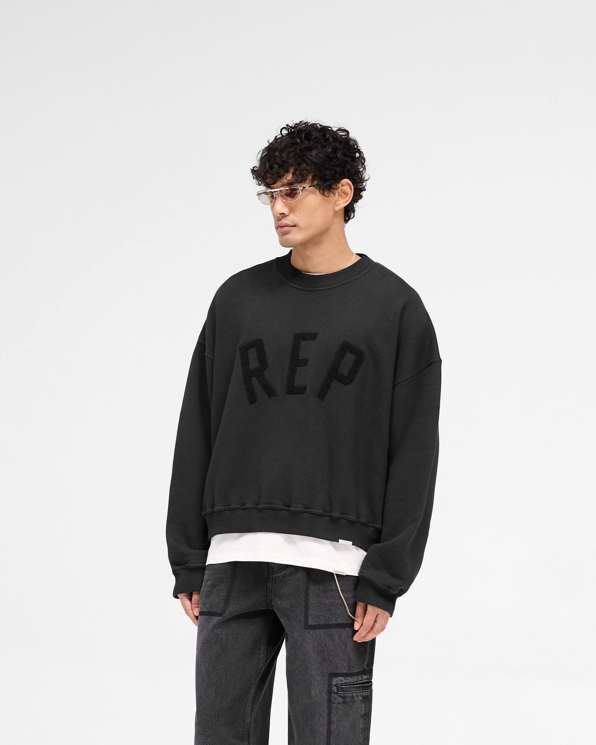 Back product image of a mens black sweater on a plain white background | Rep Applique Sweater in Off Black | Sweater with textured Rep applique | SS25 Sweaters | Represent Clo