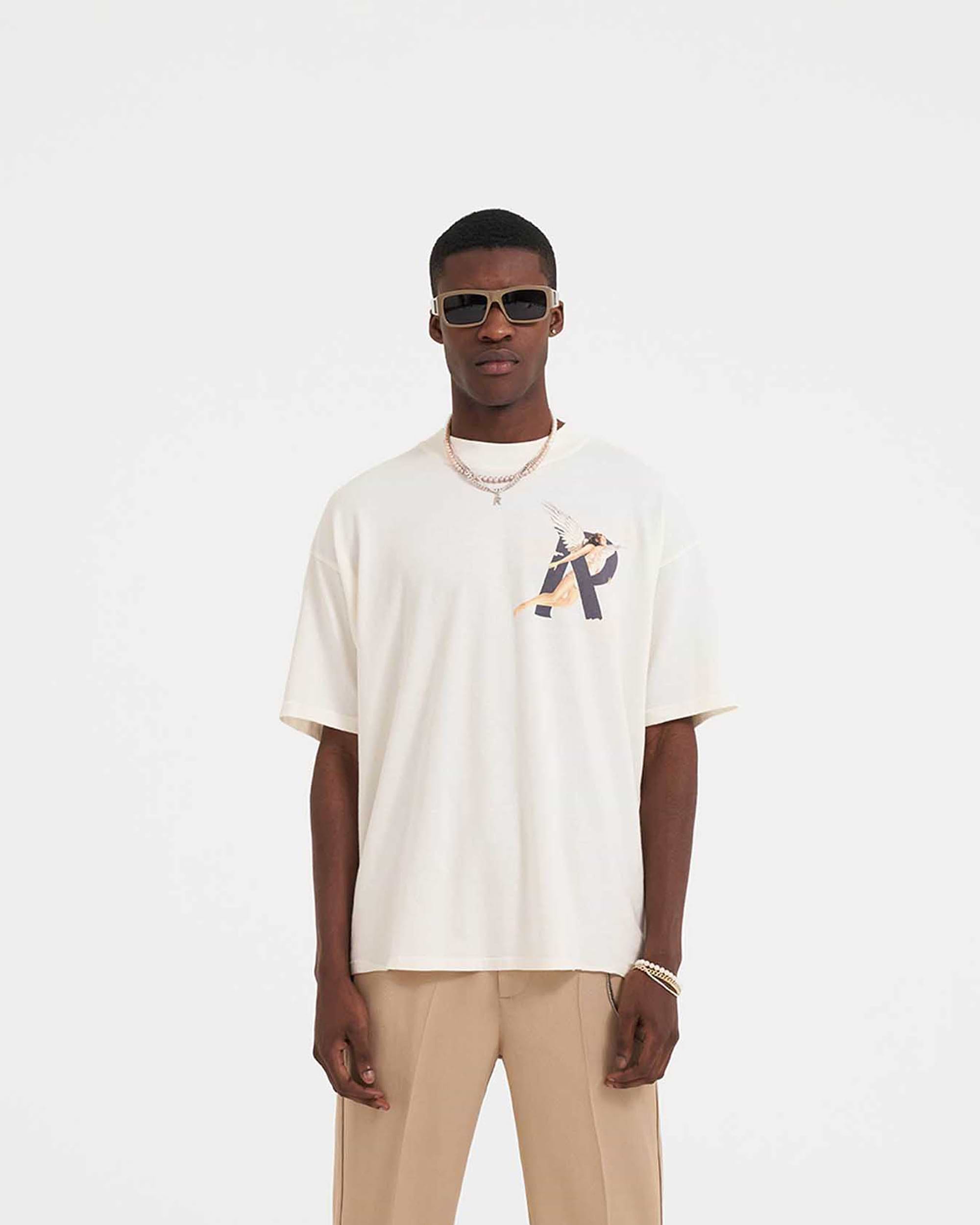 Man wearing a white graphic T-shirt on a plain white background | Storms In Heaven T-Shirt in Flat White | Oversized fit T-shirt with chest and back graphics | SS23 T-Shirts | Represent Clo