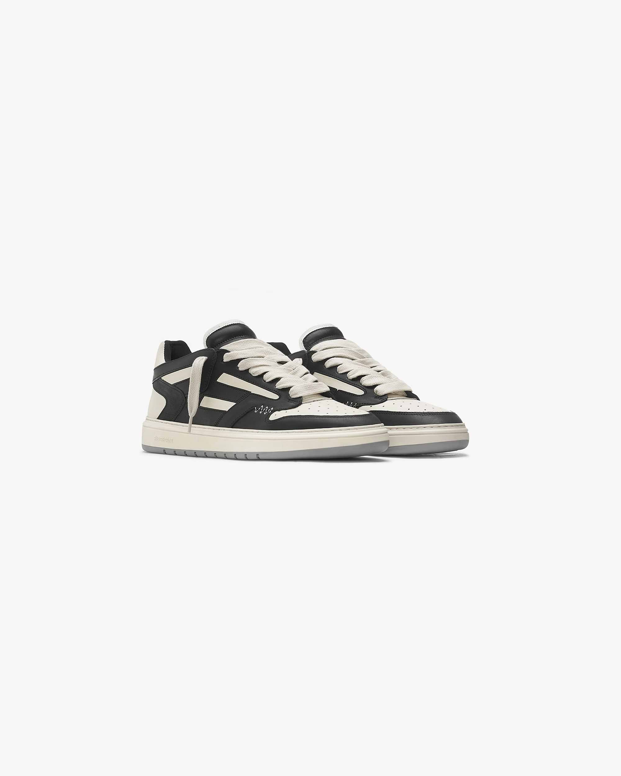 Back product image of a mens black and white trainer on a plain white background | Reptor Low in Black Vintage White | Suede and leather low top trainers with rubber outsole | FW21 Footwear | Represent Clo