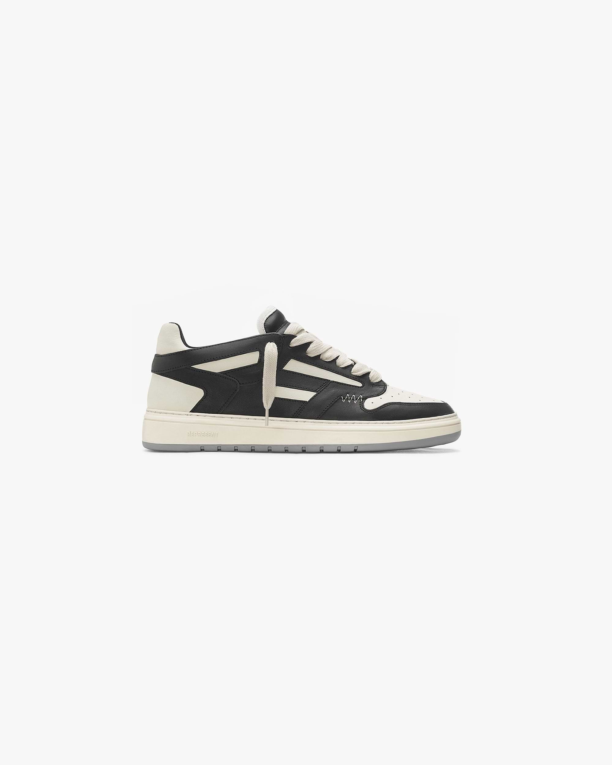 Front product image of a mens black and white shoes on a plain white background | Reptor Low in Black Vintage White | Slim fit breathable footwear with rubber logo | FW21 Footwear | Represent Clo