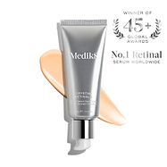 A silver pump tube of Medik8 Crystal Retinal 6 resting on a diagonal swatch of its peach-coloured cream against a clean white background. Text on the right features a silver wreath badge reading "WINNER OF 45+ GLOBAL AWARDS" and claims it is the "No.1 Retinal SERUM WORLDWIDE."