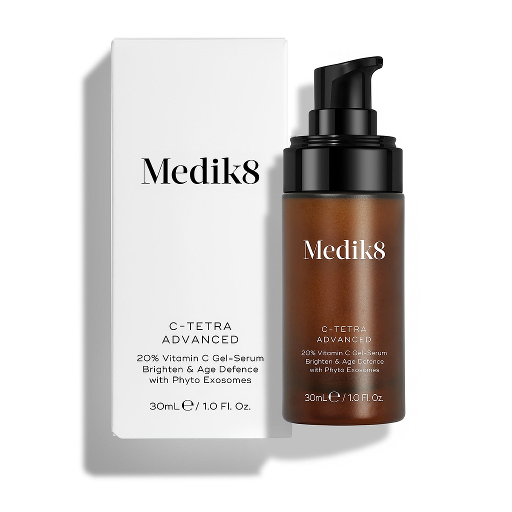 A 30mL amber pump bottle of Medik8 C-Tetra Advanced standing next to its white cardboard carton against a clean white background. Text on the bottle and carton reads "20% Vitamin C Gel-Serum," "Brighten & Age Defence," and "with Phyto Exosomes."