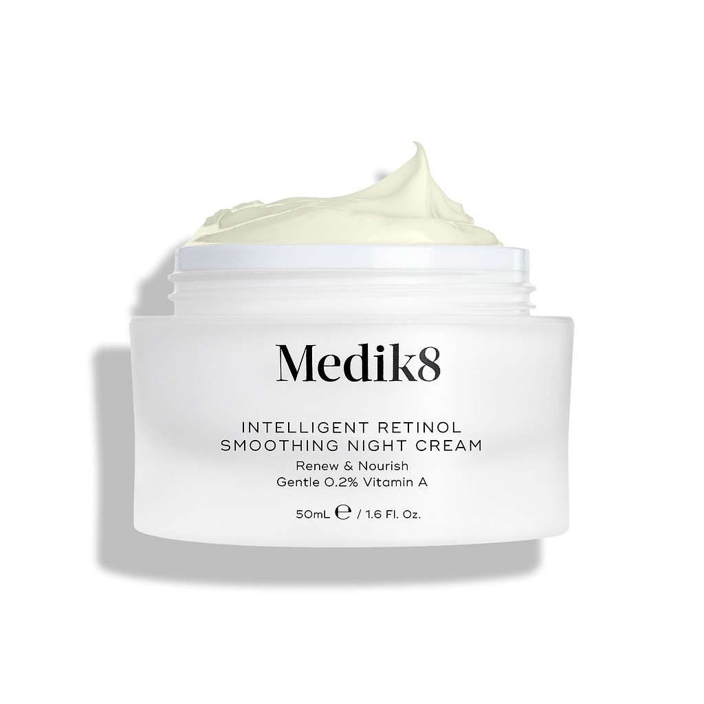 A shot of the Intelligent Retinol Smoothing Night Cream jar, open and showing the cream, on a white background. 