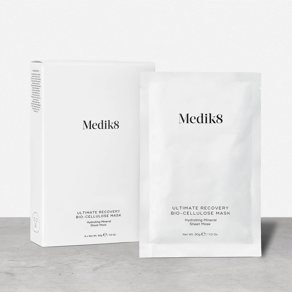 A white product carton for Ultimate Recovery Bio-Cellulose Mask stands next to a single white sachet of the mask.