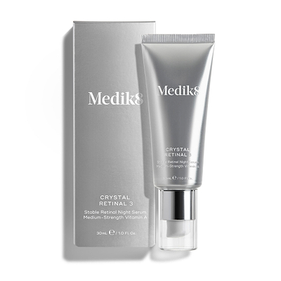 A silver tube of Crystal Retinal 3 stands beside its matching silver carton. Both display the product name