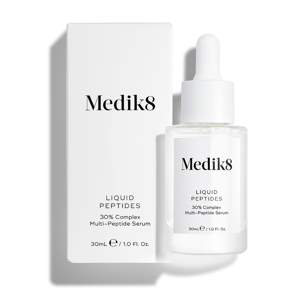 A clear glass dropper bottle of Liquid Peptides serum stands in front of its white product carton.