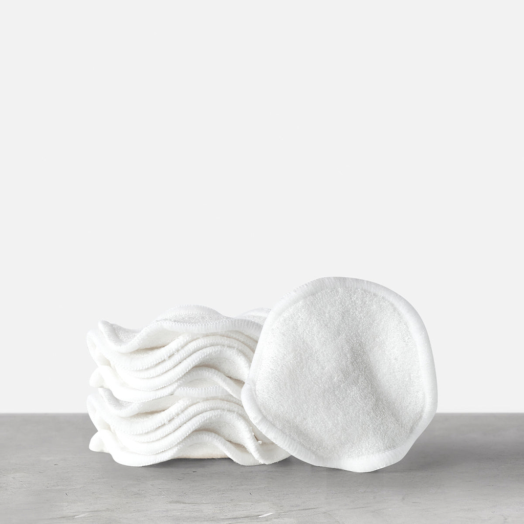 A stack of white, round reusable bamboo cotton pads