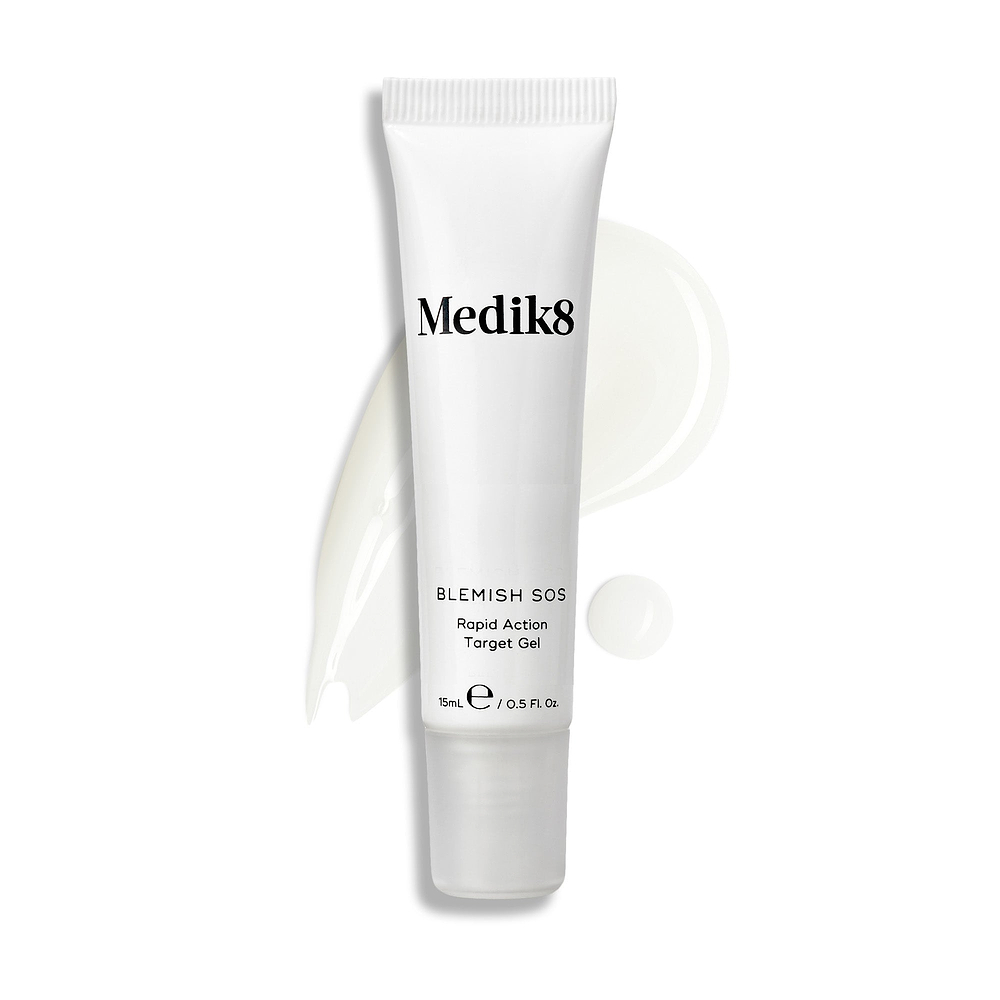Un tube de Blemish SOS se tient à la verticale, avec un trait ondulé de gel clair et une goutte à côté.