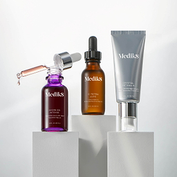 Three Medik8 skincare products on a light gray background