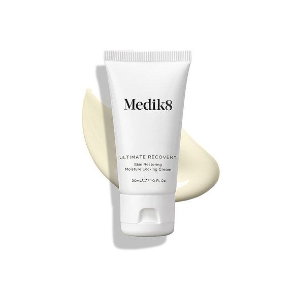 Medik8 Ultimate Recovery Skin Restoring Moisture Locking Cream tube displayed on a white background with a large, creamy swatch of the product visible behind it.-32