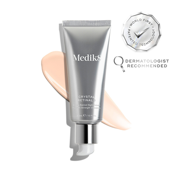 A silver tube of Crystal Retinal 3 is displayed, with a pink swatch. A WORLD FIRST PATENTED TECHNOLOGY seal and a DERMATOLOGIST RECOMMENDED icon are shown. -1