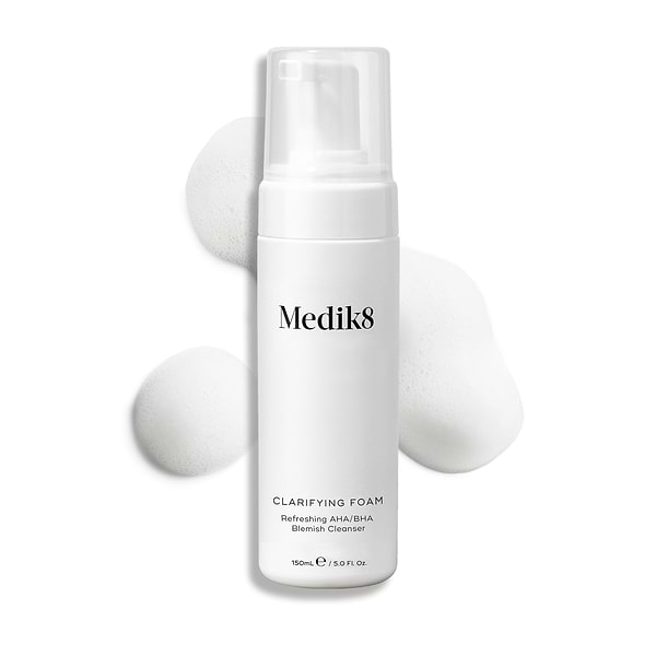 Medik8 Clarifying Foam pump bottle displayed on a clean white background with three dollops of white airy foam. Text identifies it as a Refreshing AHA/BHA Blemish Cleanser in a 150mL size.