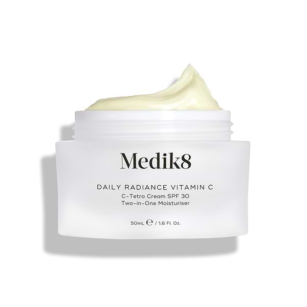 Medik8 Daily Radiance Vitamin C glass cream jar is shown open with a generous peak of pale yellow cream on top. Text identifies the product as a 50mL C-Tetra Cream SPF 30 Two-in-One Moisturiser.-9