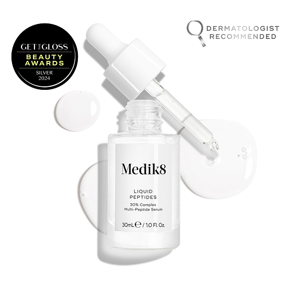 A clear glass dropper bottle of Liquid Peptides serum is presented, with its dropper removed and resting beside it and serum droplets, showing the texture.-14