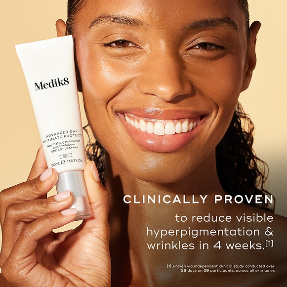 Close-up of a smiling woman with a radiant complexion holding a tube of Advanced Day Ultimate Protect. Text states: "CLINICALLY PROVEN to reduce visible hyperpigmentation & wrinkles in 4 weeks."-hover-9