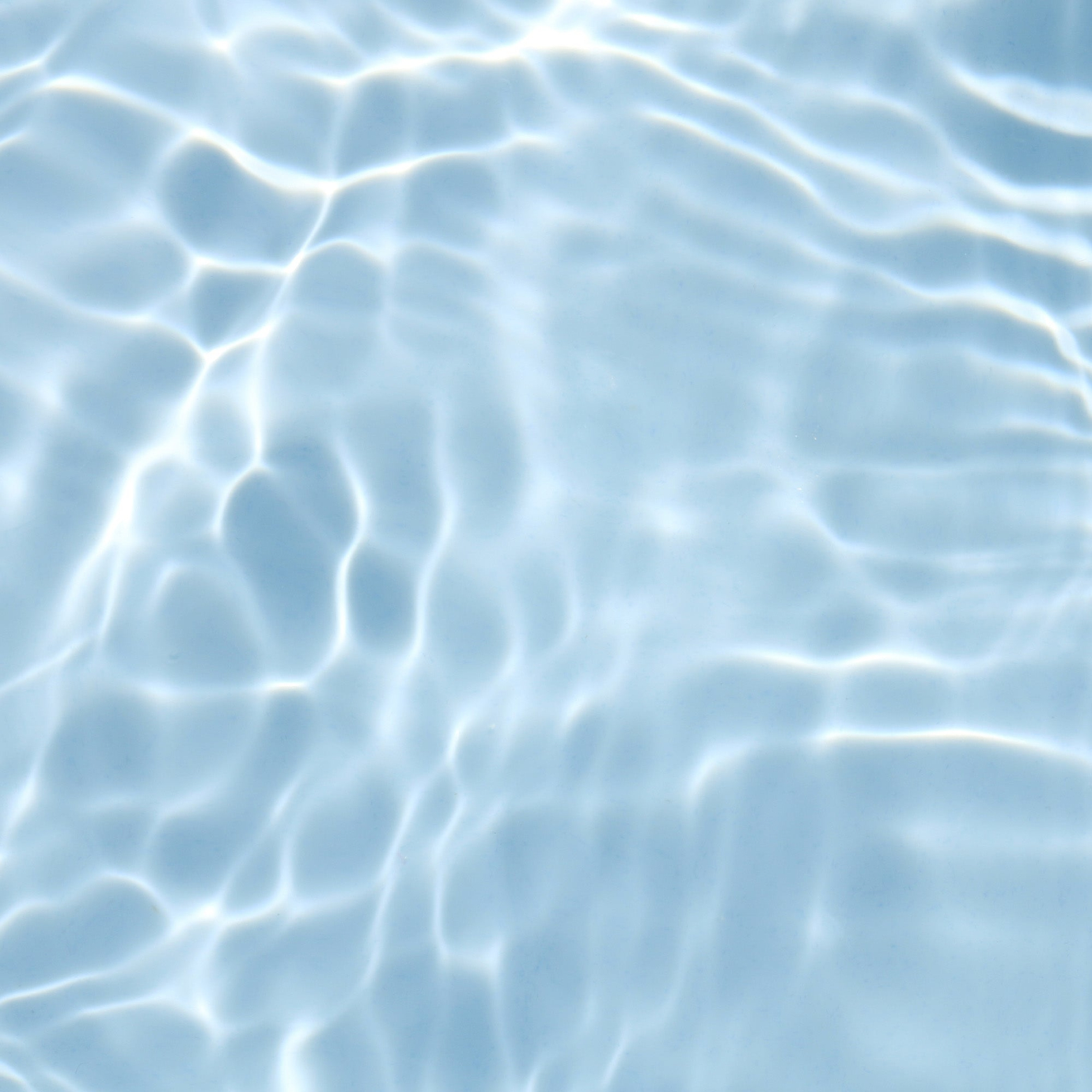 A top-down view of clear, rippling water with light reflections on a pale blue background, symbolising hydration and Hyaluronic Acid.