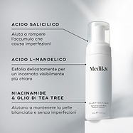 Flacone con erogatore di Medik8 Clarifying Foam posizionato su un blocco bianco su uno sfondo grigio pulito. Il testo evidenzia gli ingredienti chiave: Acido Salicilico per eliminare le impurità che causano le imperfezioni, L-Mandelic Acid per una delicata esfoliazione e un incarnato purificato, e Niacinamide & Olio di Tea Tree per aiutare a mantenere la pelle equilibrata e senza imperfezioni.