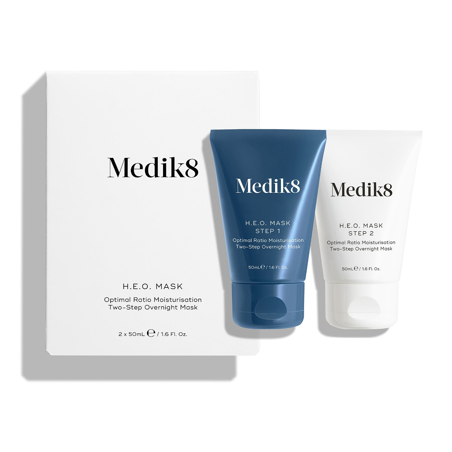 Een witte productverpakking voor het H.E.O.-masker staat naast twee tubes van het masker.