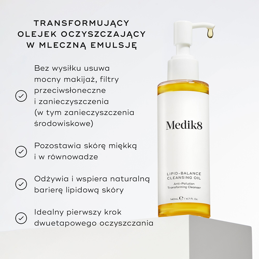 Butelka olejku oczyszczającego Lipid-Balance stoi na białym podkładce. W opisie wymieniono zalety produktu, w tym usuwanie intensywnego makijażu, wzmacnianie bariery lipidowej oraz działanie jako olejek do demakijażu, który zmienia konsystencję w mleczko.
