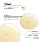Close-up de gotas de óleo dourado num fundo branco. Linhas de texto destacam os ingredientes-chave: Óleo de Cártamo para deixar a pele nutrida, suave e flexível; Ómega-6 para ajudar a reequilibrar os níveis lipídicos da pele; e Extrato de Moringa para afastar sujidade, impurezas e poluição da pele.