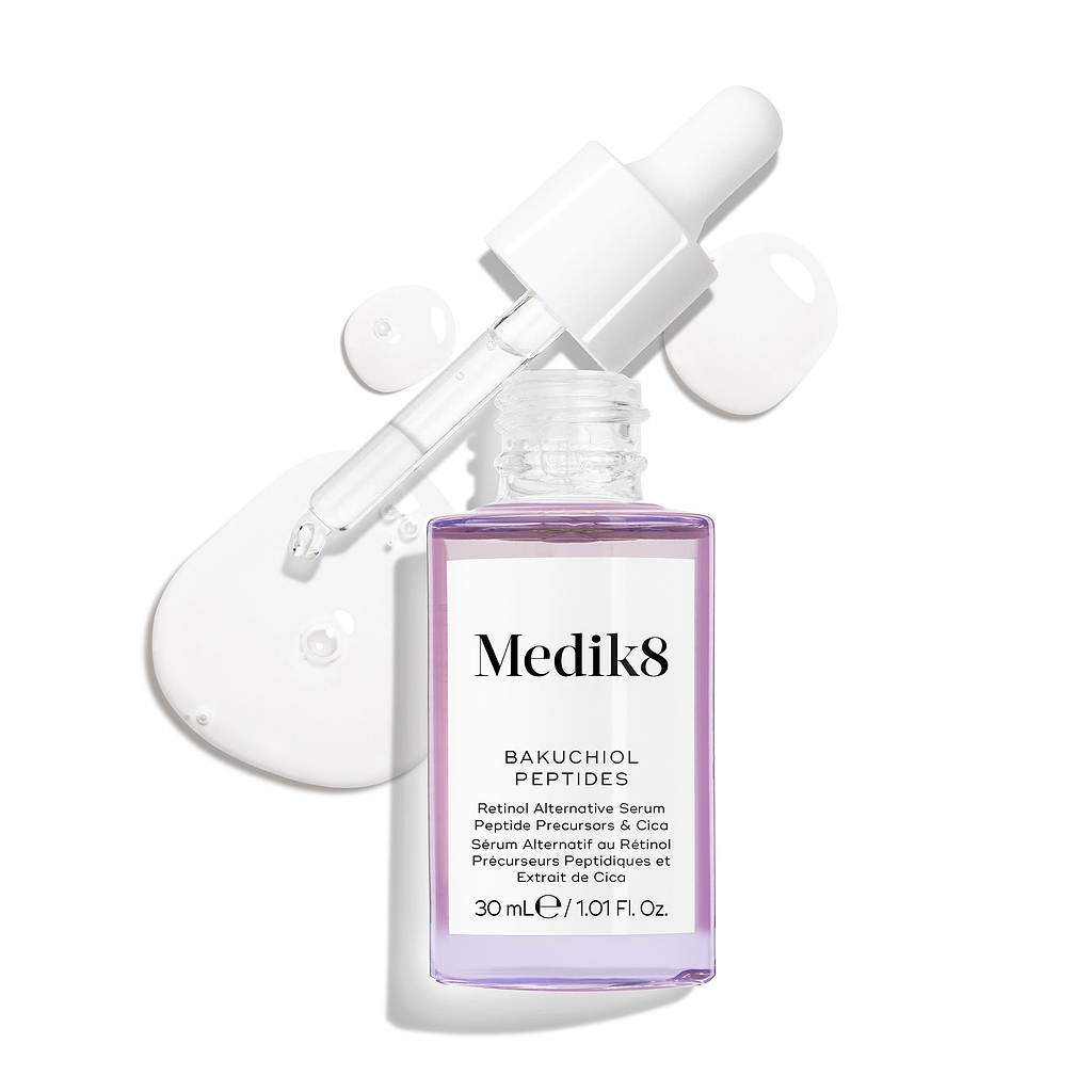 Frasco de vidro roxo com conta-gotas do sérum Bakuchiol Peptides, com a pipeta removida. Uma espiral do sérum roxo é apresentada, destacando a textura do produto.