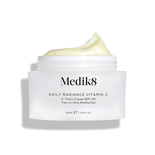 Medik8 Daily Radiance Vitamin C glass cream jar is shown open with a generous peak of pale yellow cream on top. Text identifies the product as a 50mL C-Tetra Cream SPF 30 Two-in-One Moisturiser.