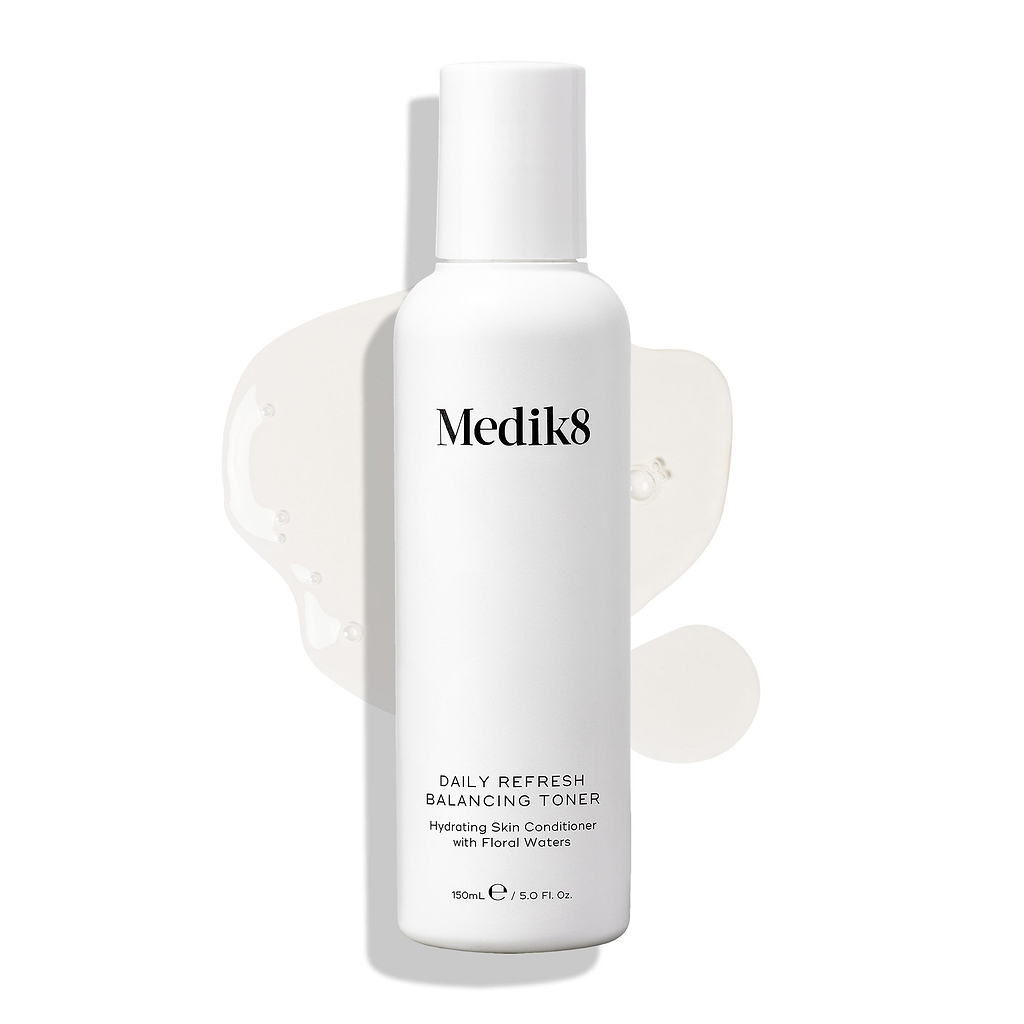 Medik8 Daily Refresh Balancing Toner bottle stands on a white background with a clear liquid spill. Text identifies it as a "Hydrating Skin Conditioner with Floral Waters" in a 150mL size.