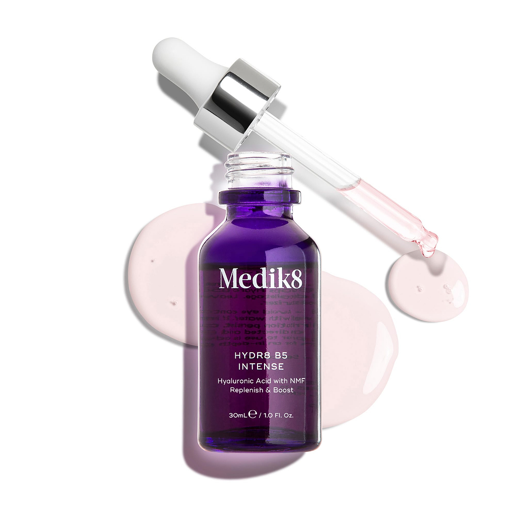 Medik8 Hydr8 B5 Intense glass dropper bottle in deep purple, shown with an open pipette resting above light pink serum droplets on a clean white background. Text highlights the formula as Hyaluronic Acid with NMF (Natural Moisturising Factors) to Replenish & Boost in a 30mL size.