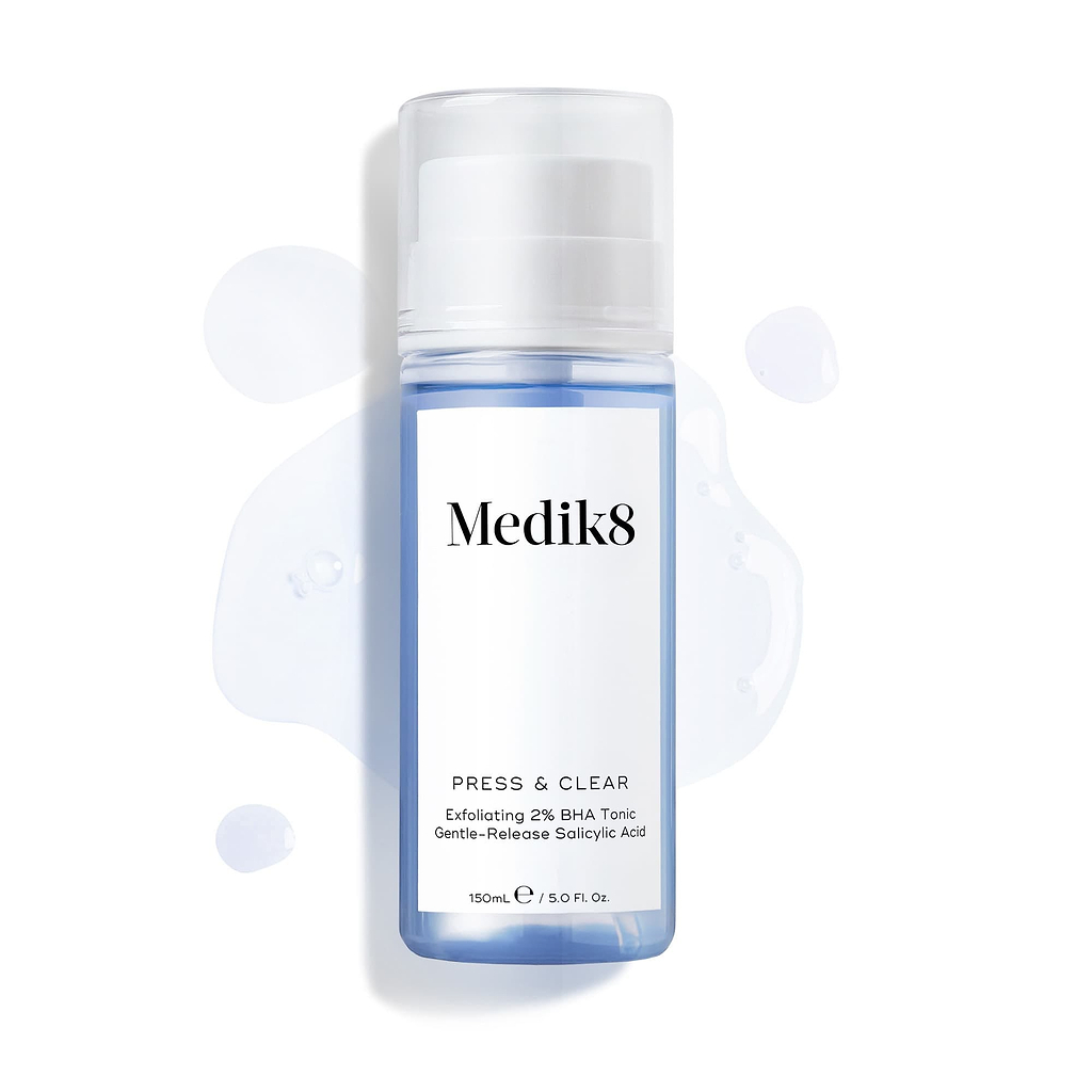 Medik8 Press & Clear bottle (150ml) displayed on a white background with splashes of blue tonic around it. Text highlights the "Exfoliating 2% BHA Tonic" formula.